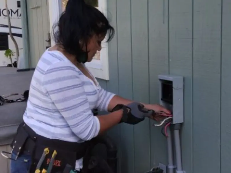 Licensed electrician wiring an exterior subpanel in Cecil